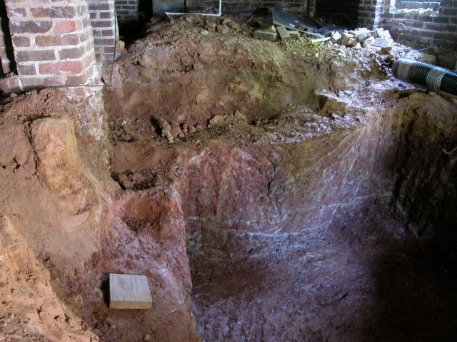 Soil excavation beneath house required by a leaking aboveground tank.