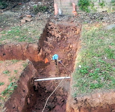 Underground tank beneath new foundation trench.