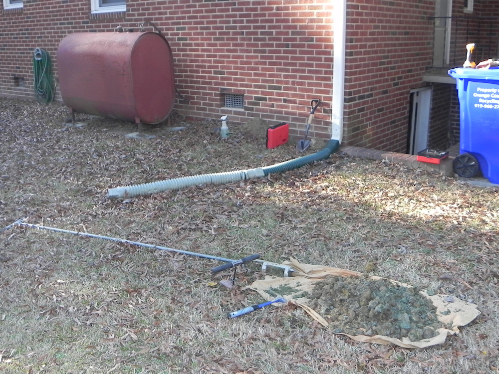 Sampling contaminated soil within slightly depressed area.
